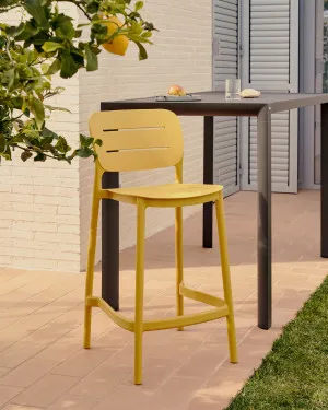 Morella stackable outdoor stool in mustard, 65 cm in height by Kave Home, a Tables for sale on Style Sourcebook
